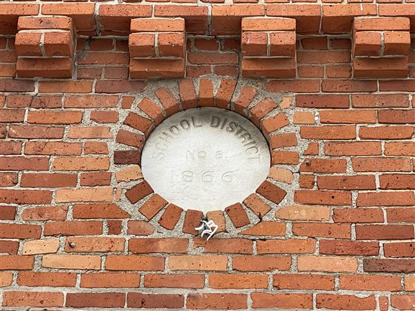 close-up of a stone feature on the building that says district 8